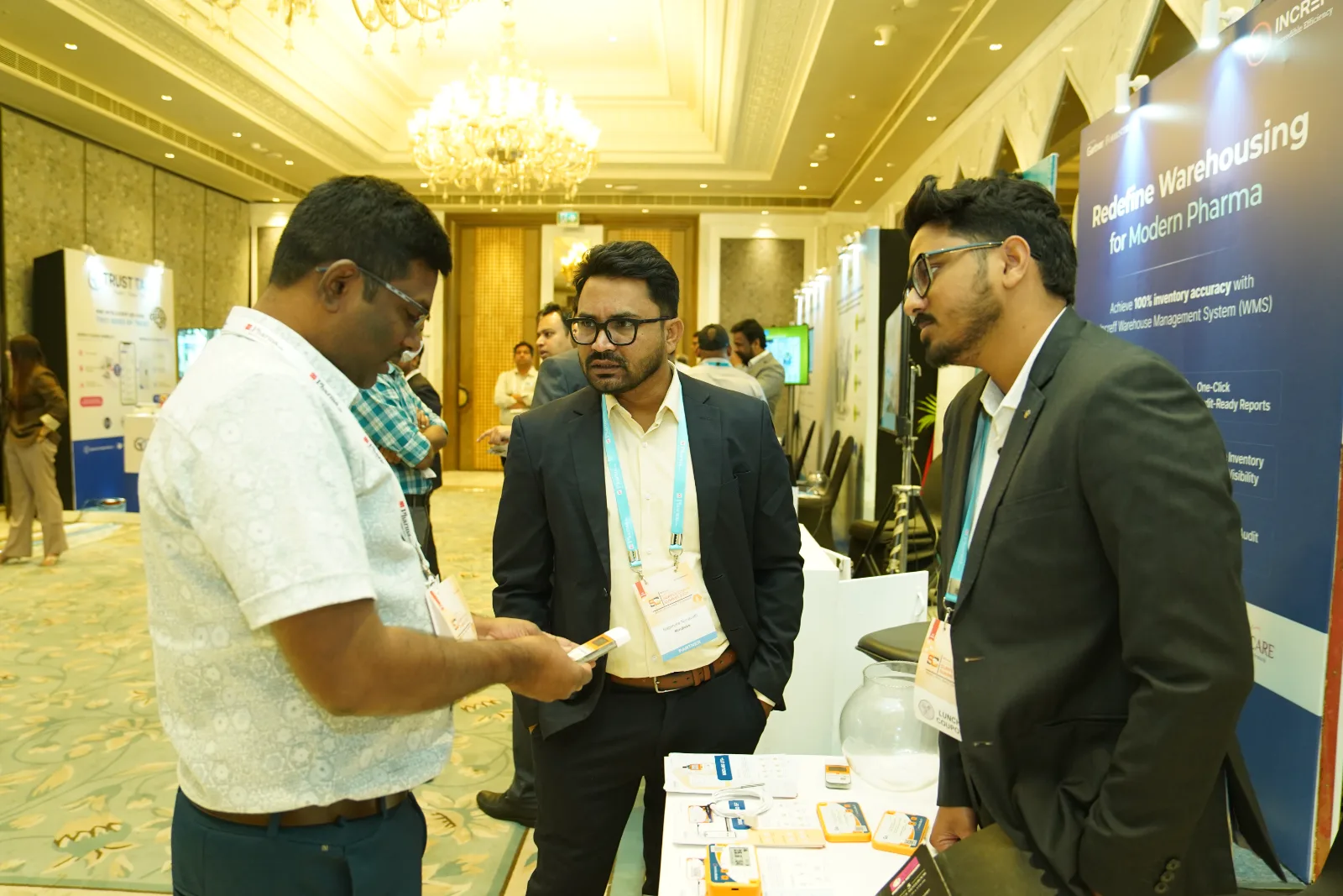 Mindlabs team demonstrating a temperature data logger to a visitor at a pharma supply chain event